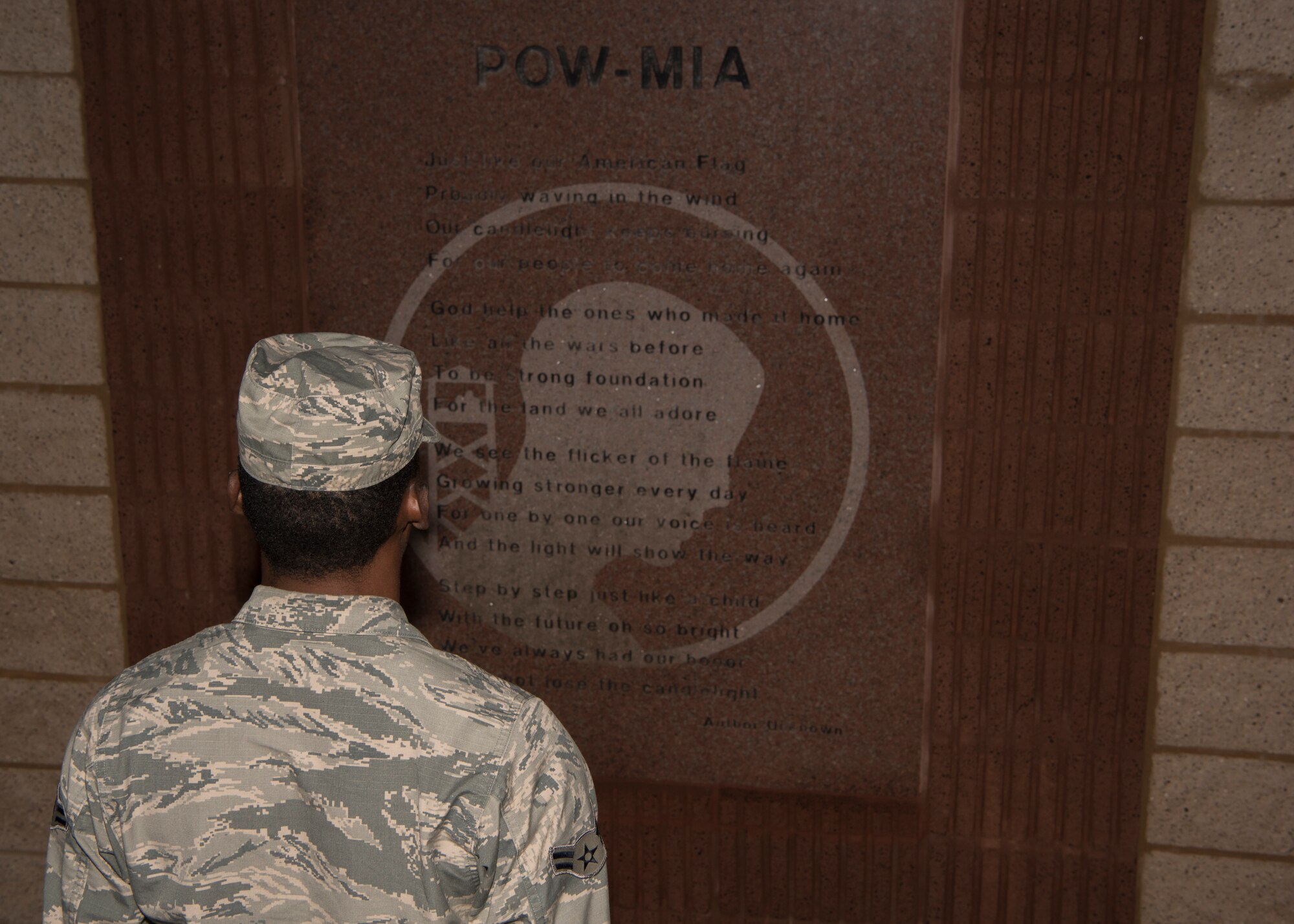 Airman 1st Class Xavier Bell, 54 Aircraft Maintenance Squadron weapons load crew member, stands at attention Sept. 21, in front of the 49th Wing Remembrance Wall. Airmen began standing at attention midnight on Sept. 21, for 30 minute periods. (U.S. Air Force photo by Airman Autumn Vogt)