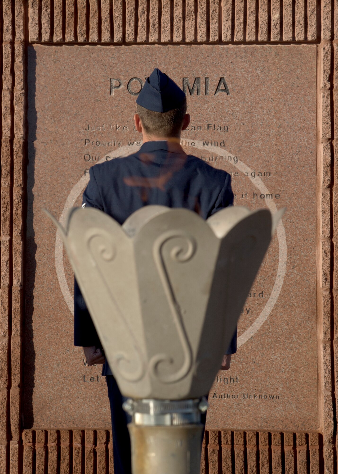 Staff Sgt. Christian Tone, an electrical systems craftsman for the 635th Material Maintenance Squadron, stands at attention in front of the POW/MIA Memorial at Heritage Park on Holloman Air Force Base, N.M., Sept. 21, as part of the 2018 POW/MIA Remembrance Day. Holloman Airmen took turns standing 24-hours straight for the vigil, honoring service members who were imprisoned and remain missing-in-action. (U.S. Air Force photo by Airman 1st Class Kindra Stewart)