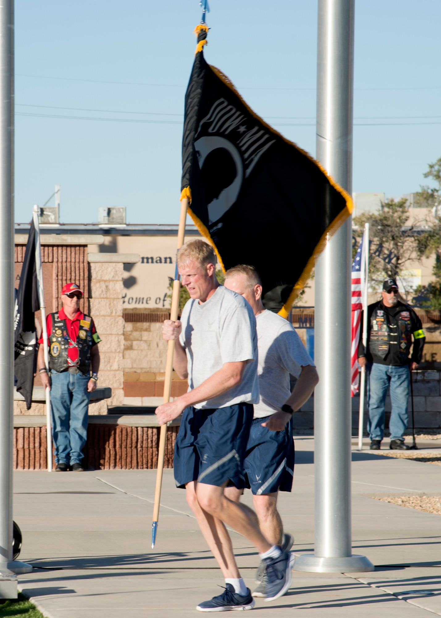 Chief Master Sgt. Timothy Wieser, 635th Material Maintenance Group Chief, runs with the POW/MIA flag during a ceremony at Heritage Park on Holloman Air Force Base, N.M., Sept. 21. The ceremony, in rememberance of prisoners-of-war and those still missing-in-action, was part of Holloman's POW/MIA commemoration. (U.S. Air Force photo by Airman 1st Class Kindra Stewart)