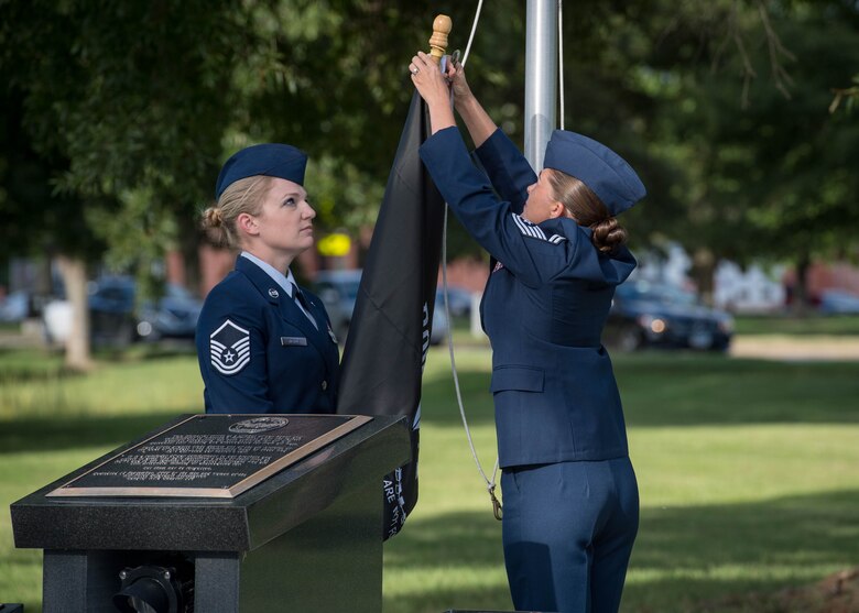 U.S. Air Force Master Sgt. Sharon Nichols, Air Combat Command Directorate of Air and Space Operations command and control operations manager, and Senior Master Sgt. Vanessa Johnston, ACC Intelligence Directorate, 1A8XX Air Force Specialty Manager, raise the POW/MIA flag during the POW/MIA 24-hour Recognition Run closing ceremony at Joint Base Langley-Eustis, Virginia, Sept. 21, 2018.