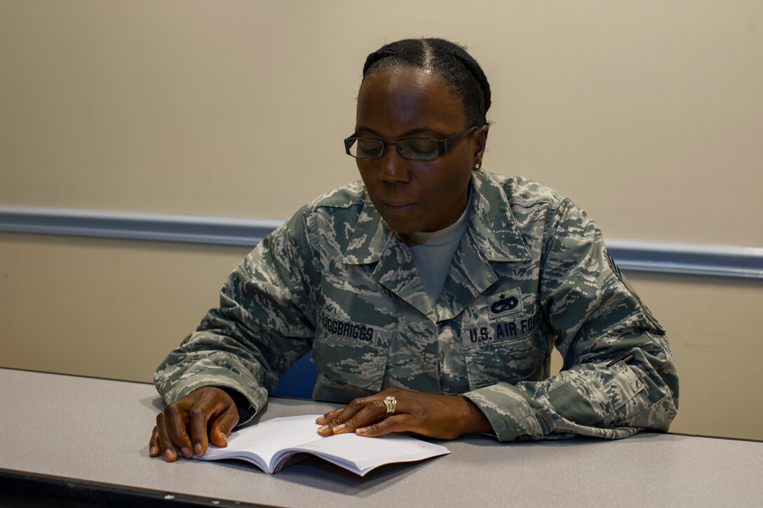 Chief Master Sgt. Sebrena FlaggBriggs, 88th Aerial Port Squadron air reserve technician at the 514th Air Mobility Wing, Joint Base McGuire-Dix-Lakehurst, N.J., poses for a photo September 4, 2018. FlaggBriggs plans to give away 10,000 books to those facing domestic violence, those needing to improve their lives and to first-term Airmen. (U.S. Air Force photo by Senior Airman Ruben Rios)