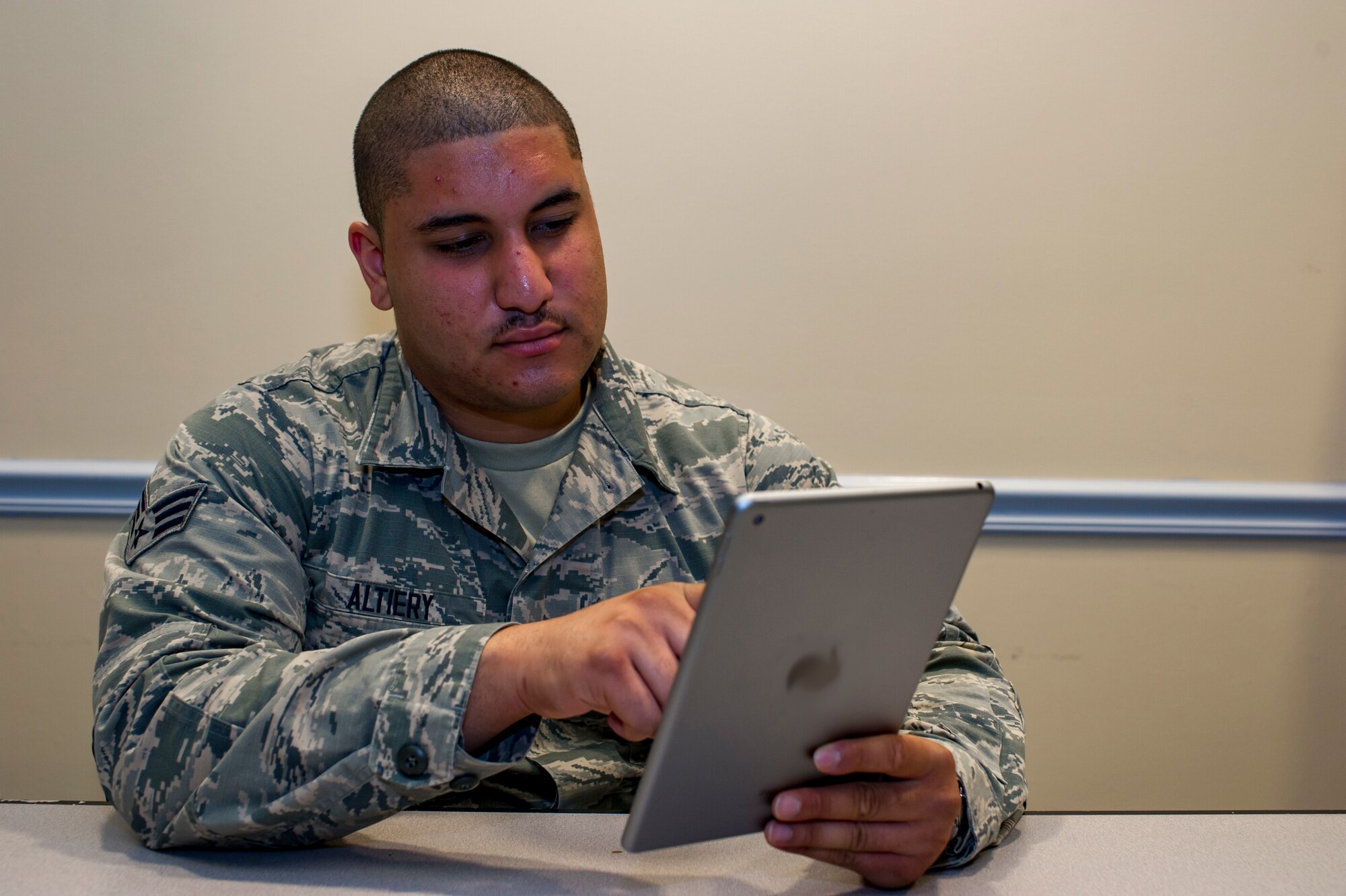 Senior Airman Pablo Altiery, an 88th Aerial Port Squadron air transportation specialist with the 514th Air Mobility Wing, Joint Base McGuire-Dix-Lakehurst, N.J., poses for a photo September 4, 2018. Altiery brainstormed his first novel in high school. (U.S. Air Force photo illustration by Senior Airman Ruben Rios)
