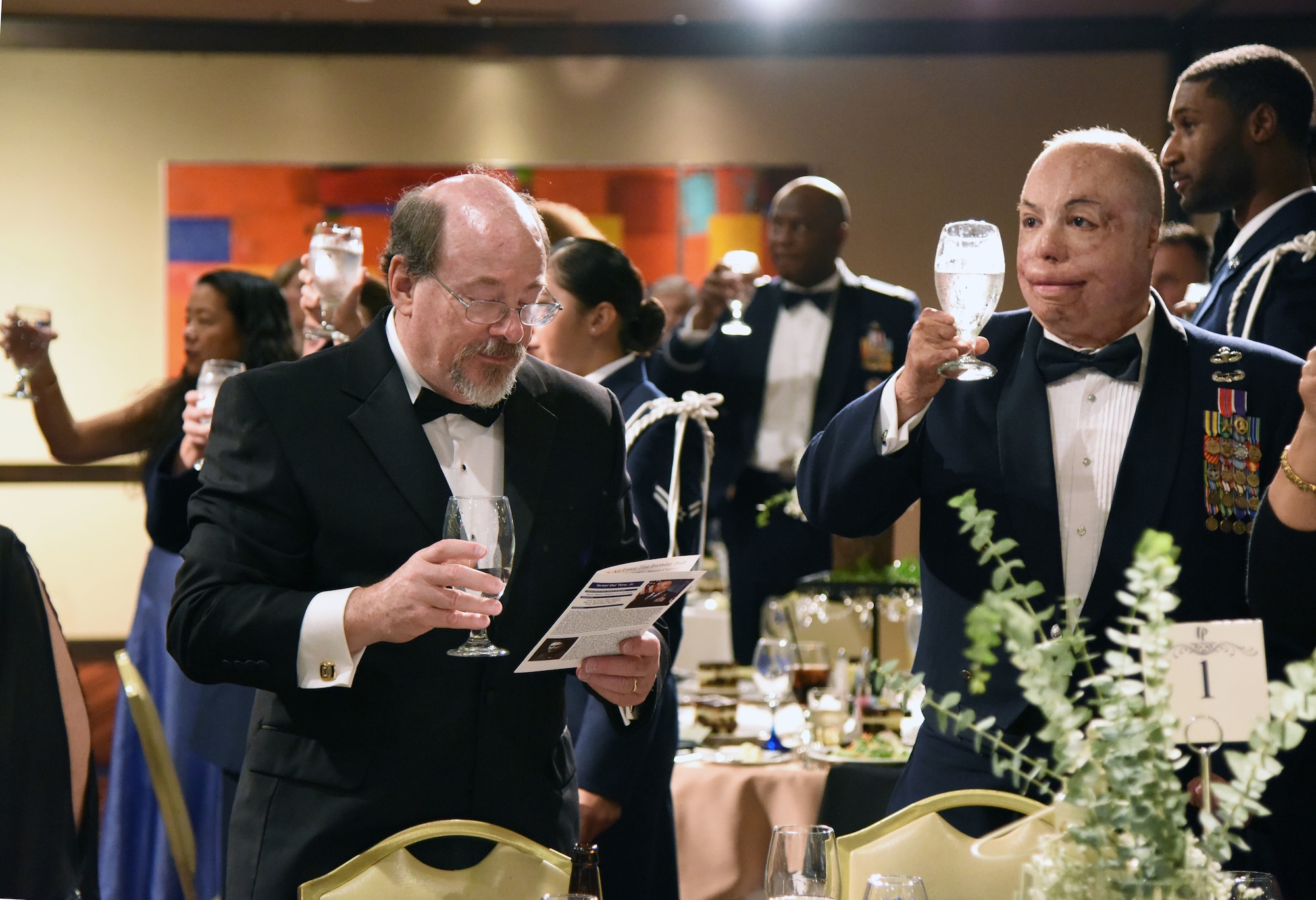 Bill Keesler, relative of 2nd Lt. Samuel Keesler, and U.S. Air Force Senior Master Sgt. Israel Del Toro, 98th Flying Training Squadron accelerated freefall training program superintendent, U.S. Air Force Academy, Colorado, hold their glasses up for a toast during the U.S Air Force 71st Birthday Ball at the Imperial Palace Casino, Biloxi, Mississippi, Sept. 22, 2018. The event, hosted by the 81st Training Wing and the John C. Stennis Chapter Air Force Association, also included a cake cutting ceremony. (U.S. Air Force photo by Kemberly Groue)