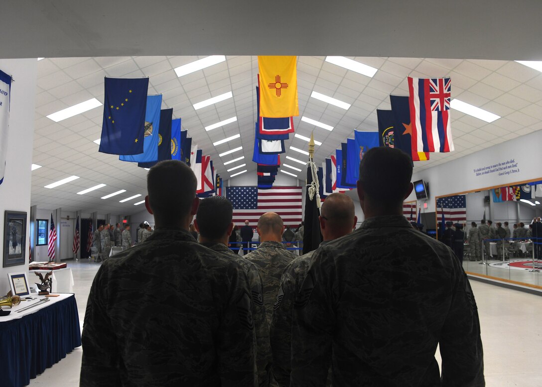 Master Sgt. Daniel Cable, 319th Operations Squadron first sergeant, center, stands at attention with his element as they wait for their cue to place a POW/MIA flag in place at a commemorative ceremony September 21, 2018, on Grand Forks Air Force Base, North Dakota. The ceremony was to honor those who are, or ever were, prisoners of war or missing in action. According to the Defense POW/MIA Accounting Agency, more than 82,000 Americans remain missing. (U.S. Air Force photo by Airman 1st Class Elora J. Martinez)