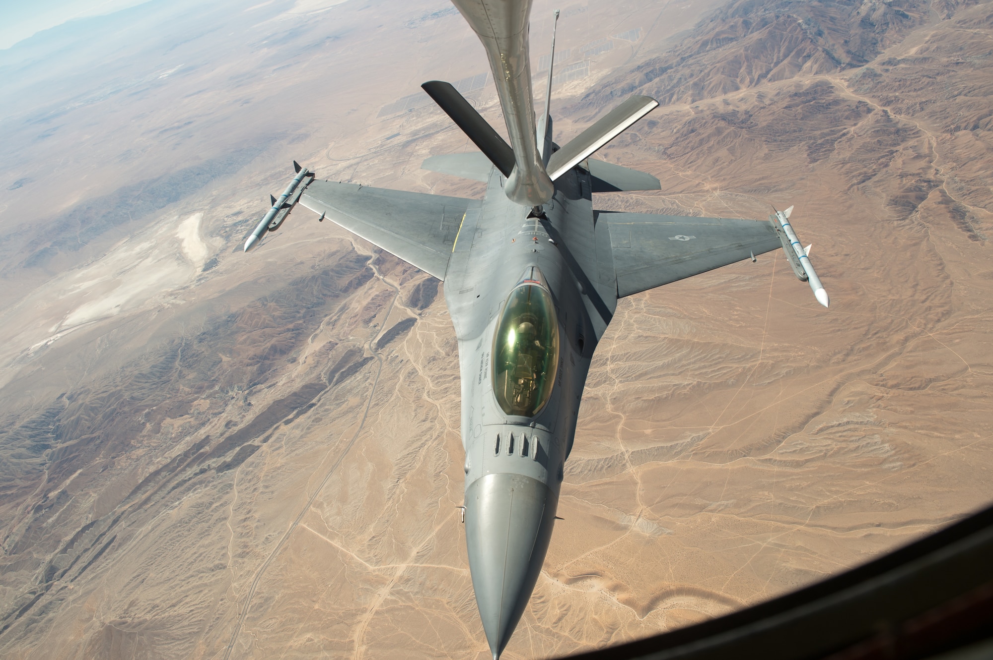 An F-16 Fighting Falcon piloted by Maj. Philip Downing, 416th Flight Test Squadron, receives fuel mid-air from a KC-135 Stratotanker over the California desert Sept. 21, 2018. The ability to conduct aerial refueling is key to the Air Force’s Global Reach mission. (U.S. Air Force photo by Kyle Larson)