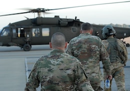 Maj. Gen. Flem B. “Donnie” Jr., commanding general, 1st Theater Sustainment Command, center, and Col. Brian Memoli, assistant chief of staff of operations, 1st TSC, approach a UH-60 Blackhawk helicopter Sept. 18.  Walker travelled to the Early Entry Command Post at Fort Knox’s Mount Eden by air to oversee field operations. (U.S. Army photo by Mr. Brent Thacker)