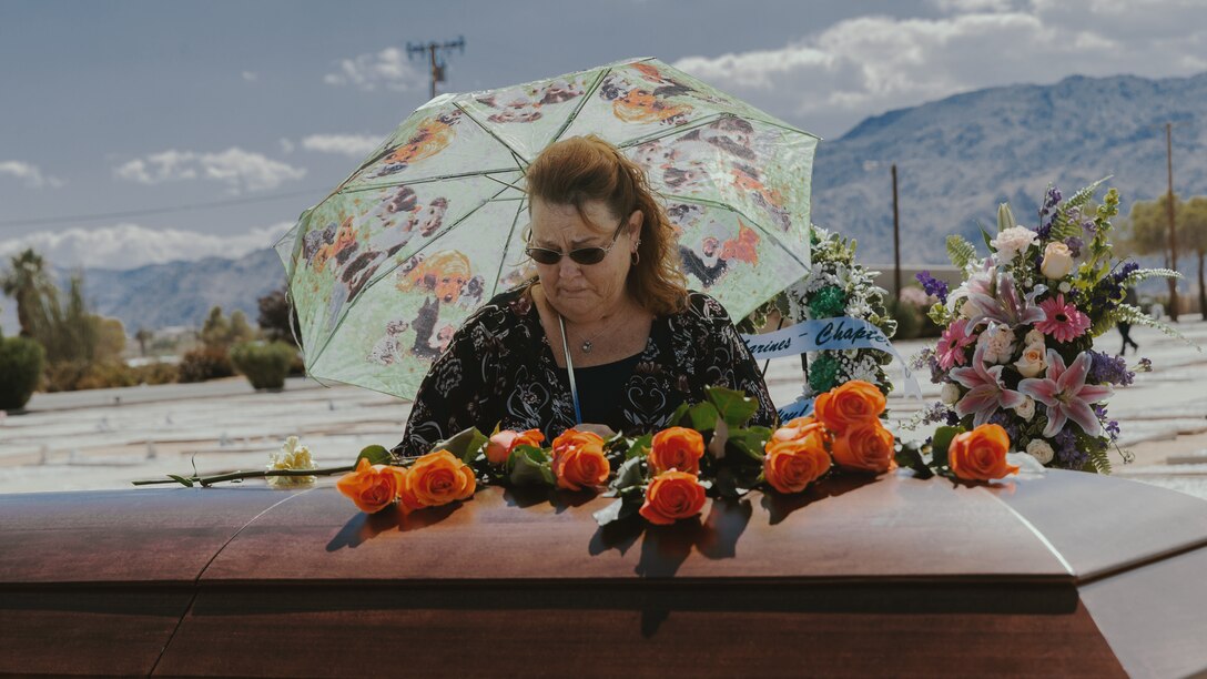 An attendee of Tech. Sgt. Dorothy L. Angil’s memorial service cries while placing a flower upon her coffin, at the Twentynine Palms Public Cemetery, Twentynine Palms, Calif., Sept. 22, 2018. Angil enlisted in the Marine Corps in 1943, in support of World War II. She also went on to support the Korean War war effort. (U.S. Marine Corps photo by Pfc. Robin Lewis)