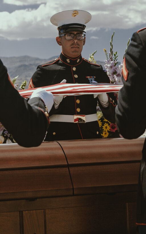 Marines with Headquarters Battalion fold a U.S. flag at the Twentynine Palms Public Cemetery, following a funeral service, in Twentynine Palms, Calif., Sept. 22, 2018. Angil enlisted in the Marine Corps in 1943, in support of World War II. She also went on to support the Korean War war effort. (U.S. Marine Corps photo by Pfc. Robin Lewis)
