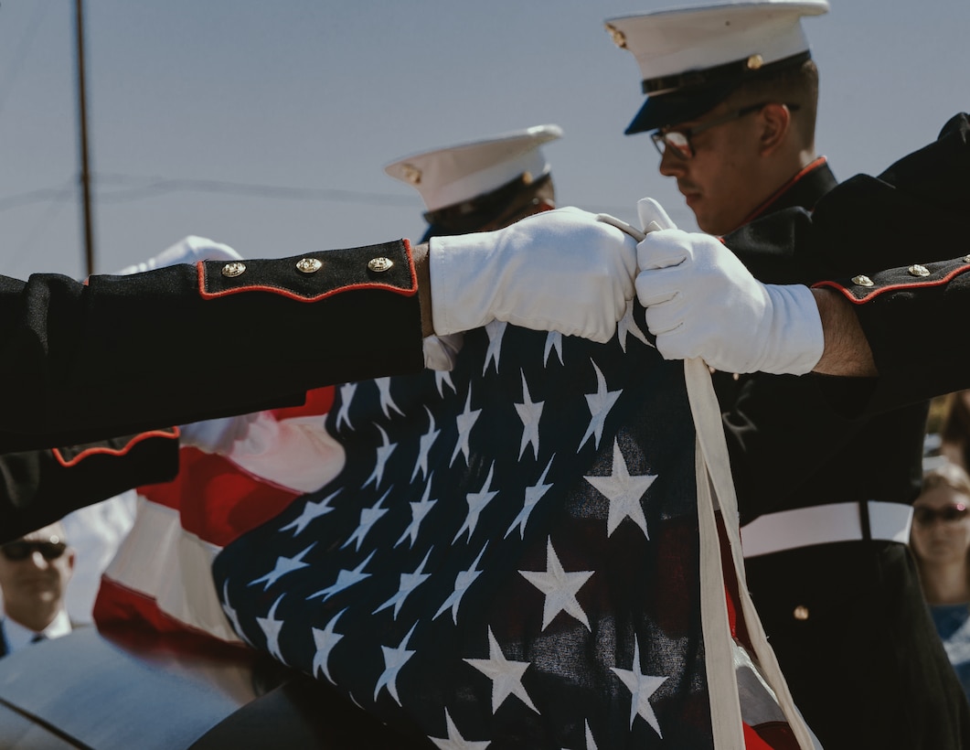 Marines with Headquarters Battalion fold a U.S. flag at the Twentynine Palms Public Cemetery, following a funeral ceremony for Tech. Sgt. Dorothy L. Angil, in Twentynine Palms, Calif., Sept. 22, 2018. Angil enlisted in the Marine Corps in 1943, in support of World War II. She also went on to support the Korean War war effort. (U.S. Marine Corps photo by Pfc. Robin Lewis)