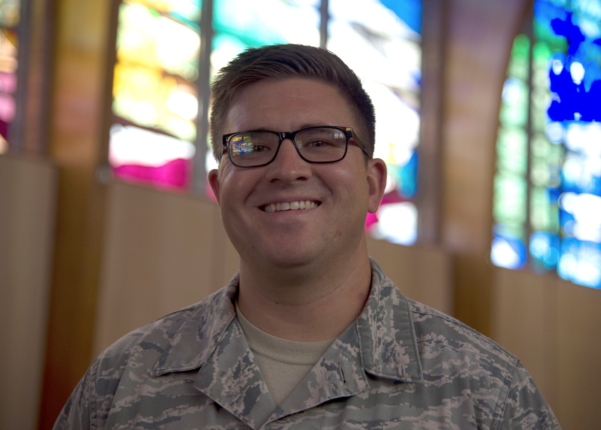 Staff Sgt. Colin Owens, 49th Wing Chapel religious affairs Airman, poses for a photo inside the base chapel Sept. 17 on Holloman Air Force Base, N.M. After cross-training from air traffic control to religious affairs, Owens arrived at Holloman in November 2017, to begin his new career. (U.S. Air Force photo by Airman 1st Class Kindra Stewart)