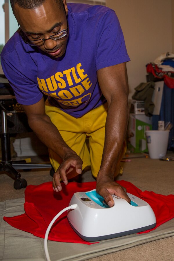 U.S. Marine Corps 1st Sgt. Michael Landry, company first sergeant, Headquarters Company, Wounded Warrior Battalion-West, Wounded Warrior Regiment, irons his logo onto a t-shirt at his home in Vista, California, September 5, 2018. During his recovery process Landry started designing and making shirts, which led him to create his own clothing line. (U.S. Marine Corps photo by Lance Cpl. Noah Rudash)