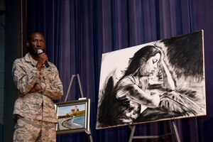 U.S. Air Force Staff Sgt. Patrick Sims, 733rd Logistics Readiness Squadron, Victim Advocate; explains the meaning behind his award winning painting “Sad” at the Sexual Assault Prevention Response event “Creating Change Through Art” held at the Langley Air Force Base Theater, Virginia, Sept. 25, 2018. SSgt Sims. (U.S. Air Force Photo by Senior Airman Ericha Guyote/Released)