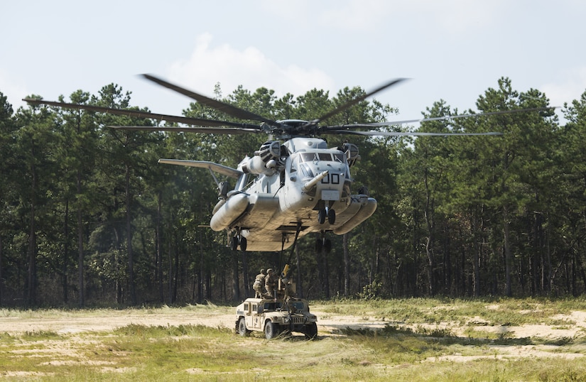 Soldiers with the 101st Airborne Division attach a U.S. Marine Corps CH-53E Super Stallion to a Humvee during a training exercise near Joint Base McGuire-Dix-Lakehurst, New Jersey, Sept. 6, 2018. Once attached, the CH-53E would lift the vehicles in the air then place them back on the ground. The sling load was repeated 10 times on five different vehicles. (U.S. Air Force photo by Airman Ariel Owings)