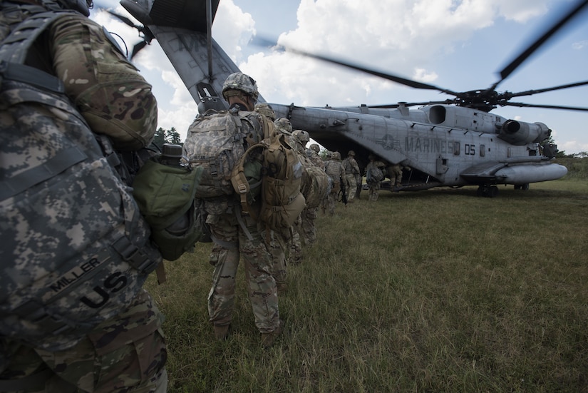 Soldiers with the 101st Airborne Division board a Marine Heavy Helicopter Squadron 772 (HMH-772) CH-53E Super Stallion during a training exercise near Joint Base McGuire-Dix-Lakehurst, New Jersey, Sept. 6, 2018. Marines with HMH-772 made 10 trips from one point to another, transporting Soldiers for reconnaissance missions. (U.S. Air Force photo by Airman Ariel Owings)