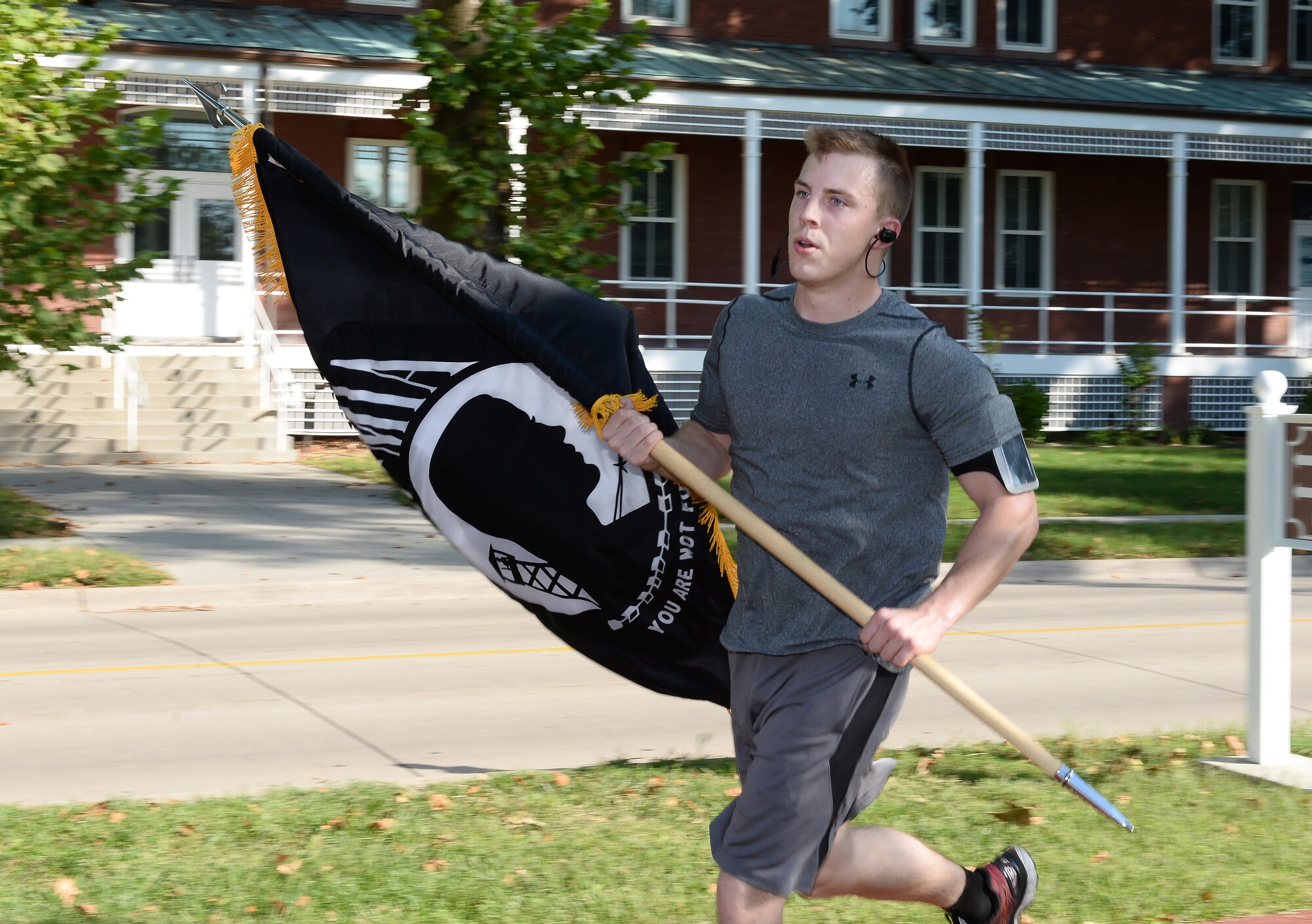 U.S. Air Force Staff Sgt. Matthew Green, 373rd Training Squadron instrument flight control systems instruction, carries the POW/MIA flag during the POW/MIA l 24-Hour Vigil Run Sept. 14, 2018, at Offutt Air Force Base, Nebraska. The United States’ National POW/MIA Recognition Day is observed across the nation on the third Friday of September each year. (U.S. Air Force Photo by Charles J. Haymond)