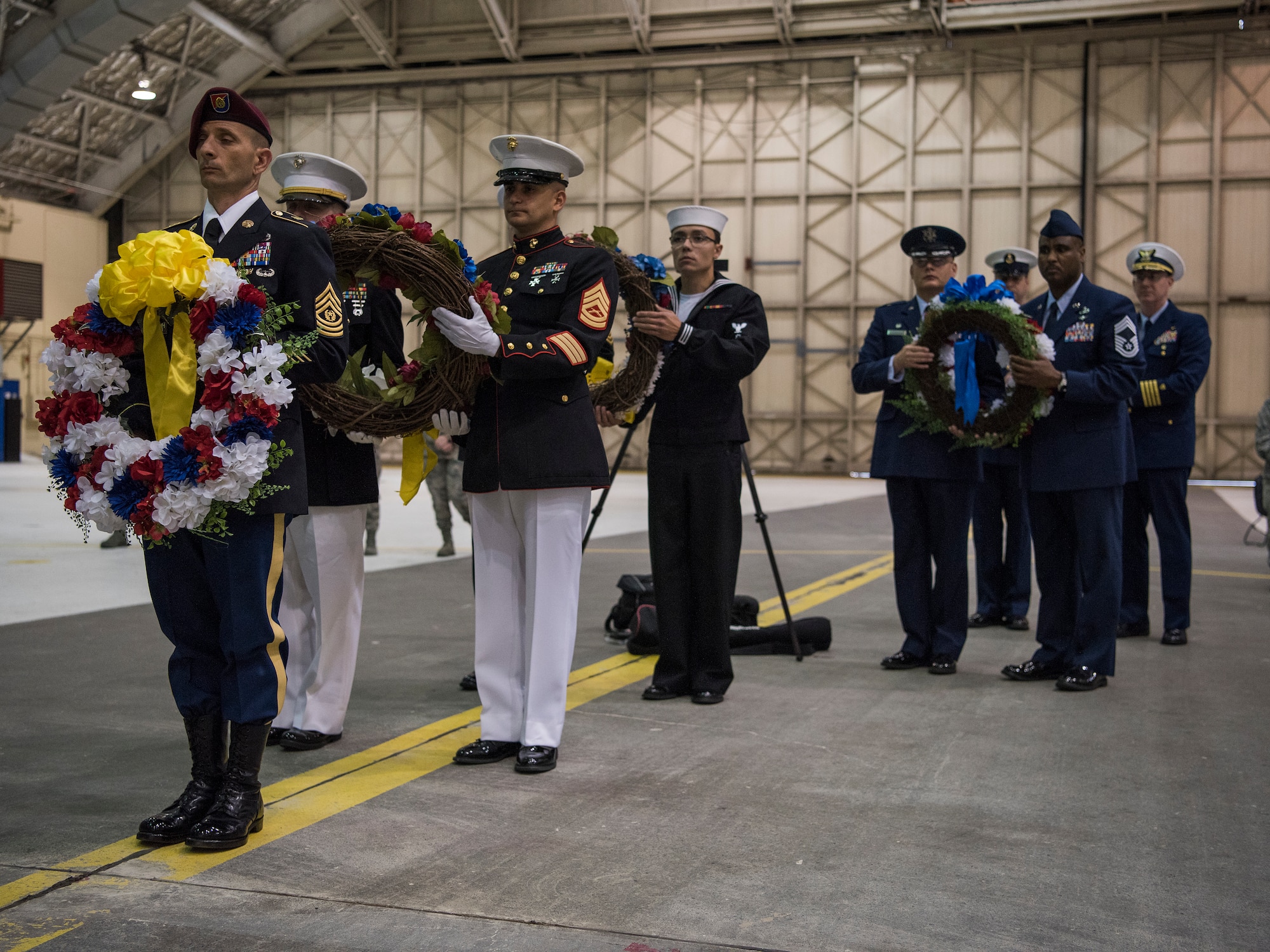 Joint Base Elmendorf-Richardson service members present wreaths at a POW/MIA recognition ceremony at Hangar 1, JBER, Alaska, Sept. 21, 2018. POW/MIA recognition day is observed every year on the third Friday in September and honors those who were prisoners of war and those who are still missing in action.