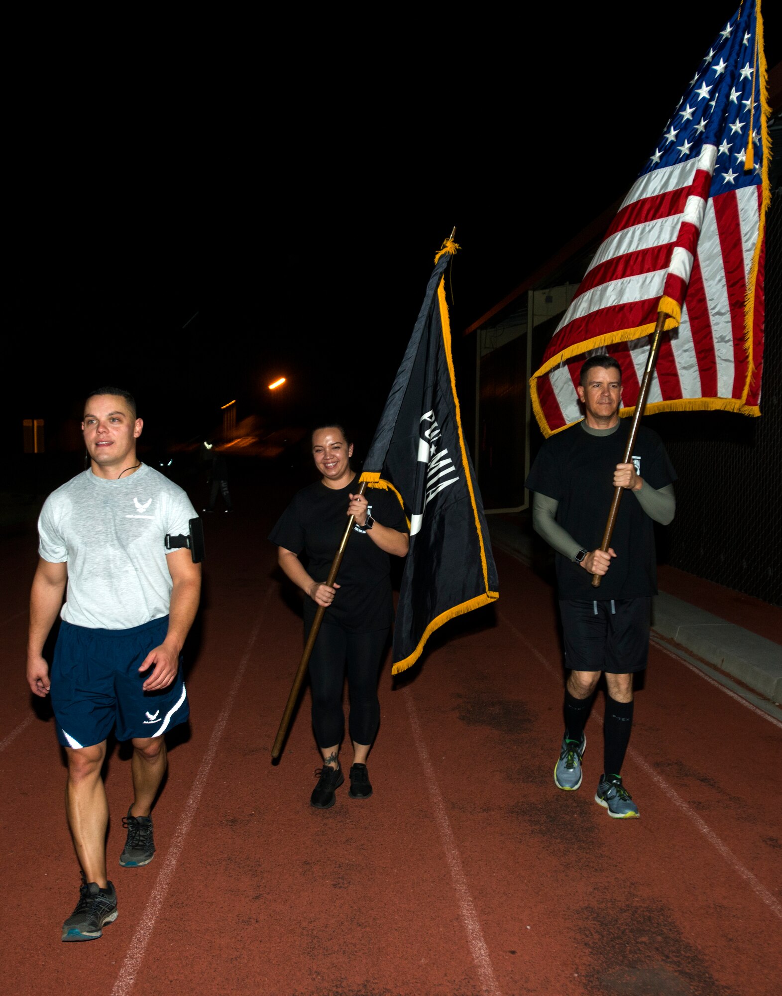 Members of the 349th Air Mobility Wing carry the American Flag and POW/MIA flag during the POW/MIA Recognition Day ceremony run at Travis Air Force Base, Calif., on Sept. 21, 2018. Team Travis Airmen kept the flag in constant motion for 24 hours straight in honor of American prisoners of war and those missing in action.