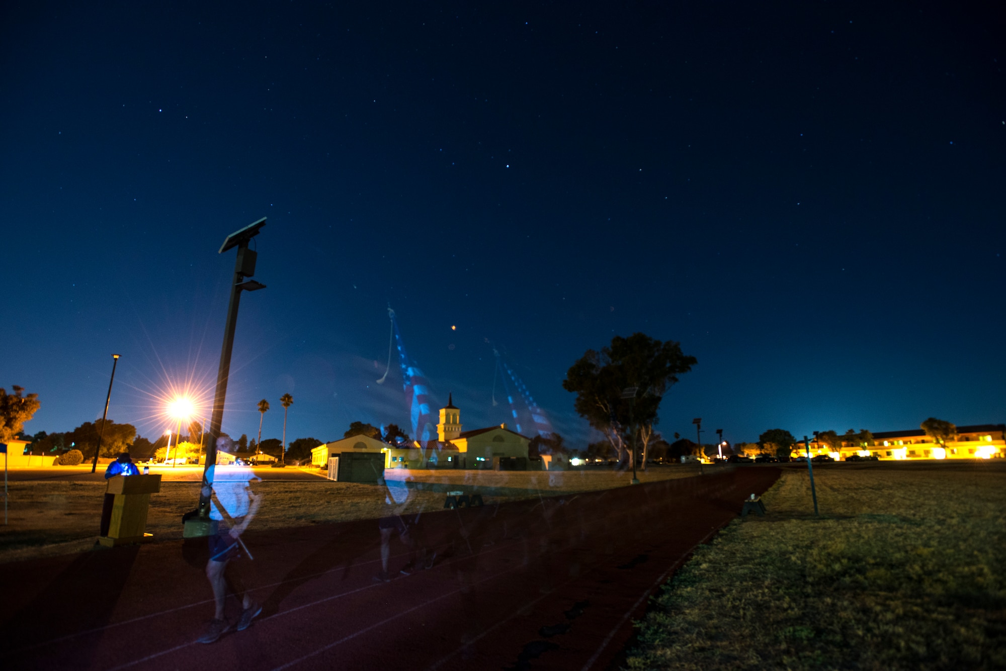 Members of the 349th Air Mobility Wing carry the American Flag and POW/MIA flag during the POW/MIA Recognition Day ceremony run at Travis Air Force Base, Calif., on Sept. 21, 2018. Team Travis Airmen kept the flag in constant motion for 24 hours straight in honor of American prisoners of war and those missing in action.