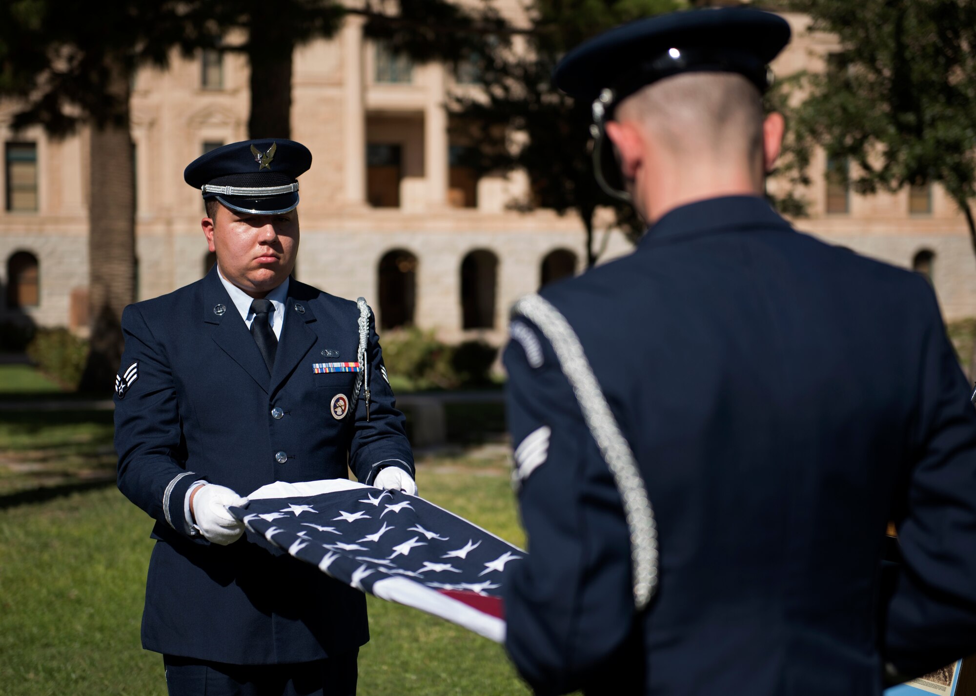 Members of the 56th Fighter Wing honor guard fold a flag to present to Donald Luke, the nephew of WWI fighter ace 2nd Lt. Frank Luke Jr., during a ceremony in his remembrance Sept. 26, 2018, at the state capitol in Phoenix, Ariz. Luke Jr. was killed after refusing to surrender to enemy forces after being shot down in his final mission. (U.S. Air Force photo by Senior Airman Ridge Shan)