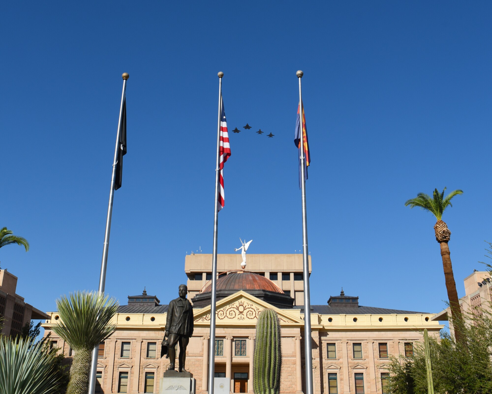 Two F-35A Lightning IIs along with two F-16 Fighting Falcons fly in formation over the Arizona State Capitol building during a ceremony for the 100th anniversary of the death Lt. Frank Luke Jr. Sept. 26, 2018 in Phoenix.