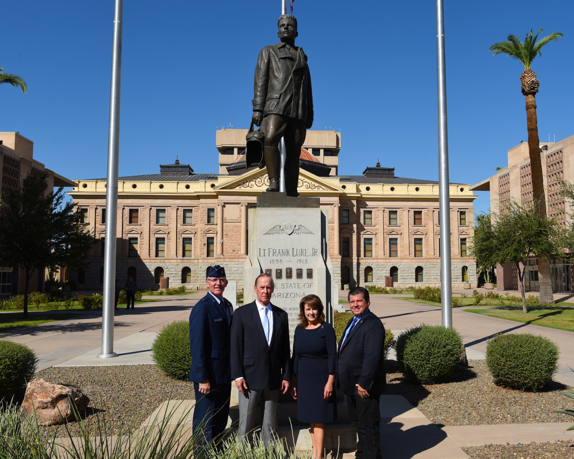 From left, Brig. Gen. Todd Canterbury, 56th Fighter Wing commander, Donald Luke, nephew of Lt Frank Luke Jr., Sen. Sine Kerr, Arizona State Senator and Rep. Tim Dunn Arizona House of Representatives pose for a photo in front of a statue representing Lt. Frank Luke Jr. Sept. 26, 2018 in Phoenix.