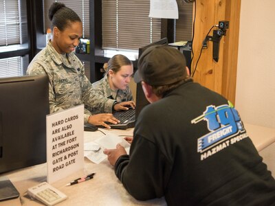 Airman 1st Class Kaylon Thomas, a 673d Security Forces Squadron Visitor Control Center technician, works with Blake Horn to renew a base visitor’s pass at the Boniface VCC at Joint Base Elmendorf-Richardson, Alaska, Sept. 20, 2018. Technicians provide customer service to individuals desiring base access, they are the front-line of installation security and must be thorough with every situation at the gates.