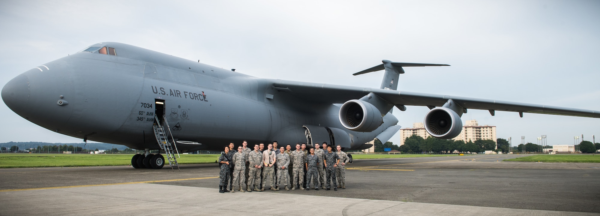 U.S. Air Force and Japan Air Self-Defense Force members pose for a photo in front of a C-5 Super Galaxy