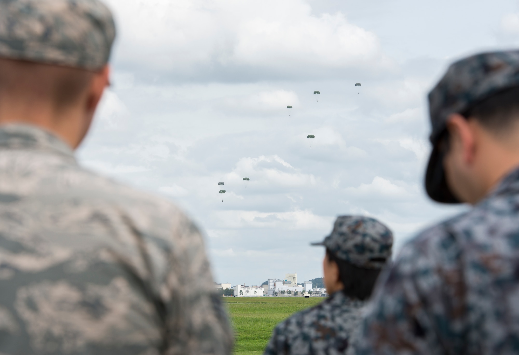 Members from the Bilateral Exchange Program watch as the U.S. Army 1st Special Forces Group performs a jump training