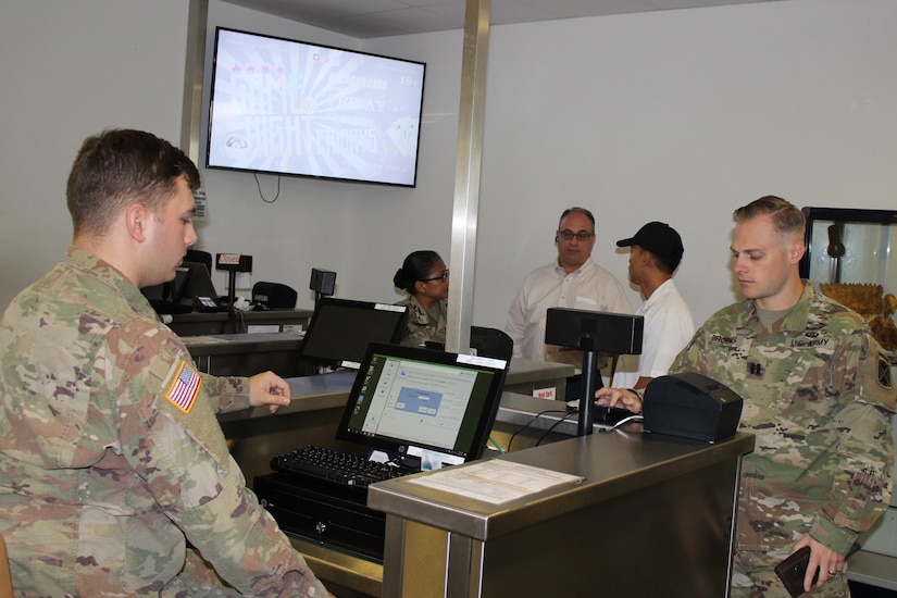 Pvt. Daniel Wilson, 212th Combat Support Hospital, accepts payment from Cpt. Timothy Brocks, 10th Army Air and Missile Defense Command, at the Defender Café, dining facility on Rhine Ordnance Barracks, Kaiserslautern Germany. The Defender Café is one of 14 dining facilities in Europe, recently adding credit and debit card payment as option to their program. The U.S. Army is the first service branch to implement card services at dining facilities and dining facilities in Europe piloted the program.