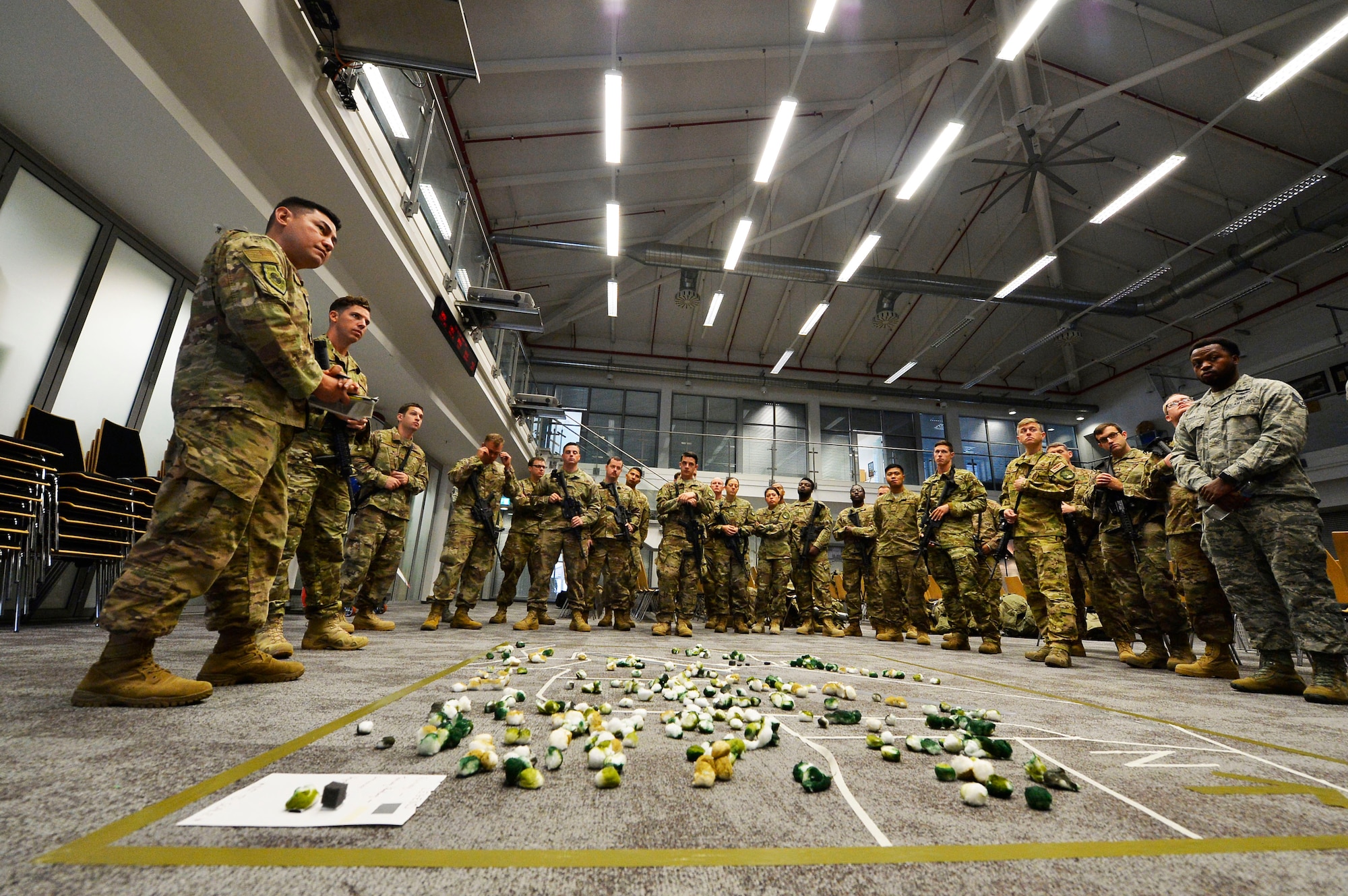 U.S. Airmen assigned to the 435th Contingency Response Group listen to a mission brief for Exercise Saber Junction on Ramstein Air Base, Germany, Sept. 25, 2018. Some Airmen are expected to support Saber Junction in Hohenfels, Germany, while the rest will conduct auxiliary training on Ramstein. (U.S. Air Force photo by Senior Airman Joshua Magbanua)