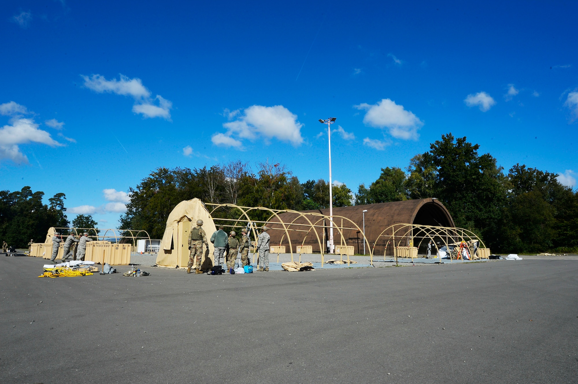 U.S. Airmen assigned to the 435th Contingency Response Group build tents on Ramstein Air Base, Germany, Sept. 25, 2018. While the 435th CRG contains Airmen who hail from a variety of Air Force specialty codes, the Airmen train in numerous contingency response tasks such as establishing temporary operating locations. (U.S. Air Force photo by Senior Airman Joshua Magbanua)