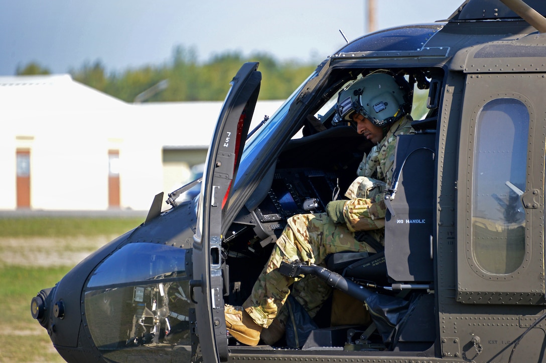 An Army pilot prepares his UH-60M Black Hawk helicopter for flight before conducting rappelling training.