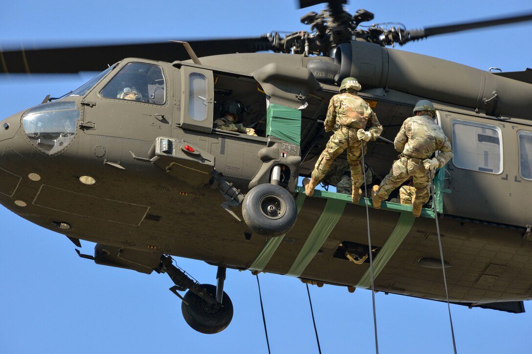 Soldiers prepare to rappel from UH-60M Black Hawk helicopters during an air assault course.