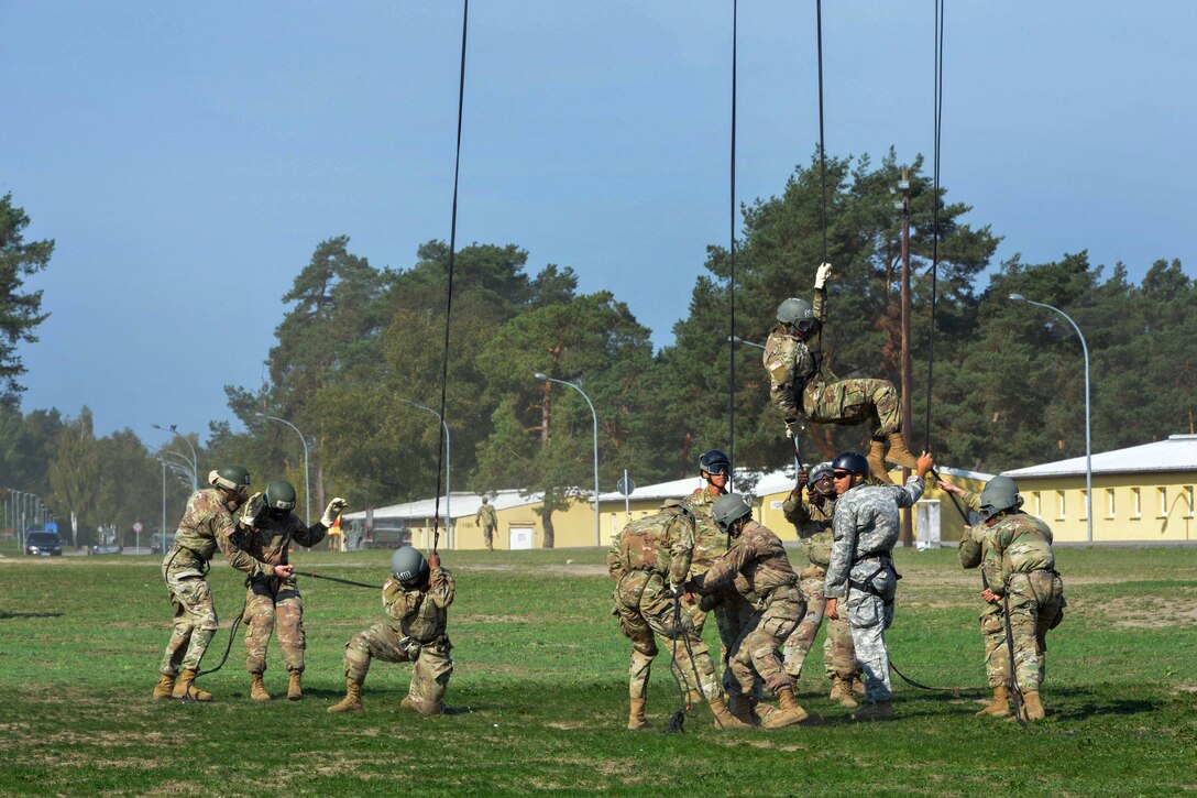 Soldiers rappel from UH-60M Black Hawk helicopters during an air assault course.