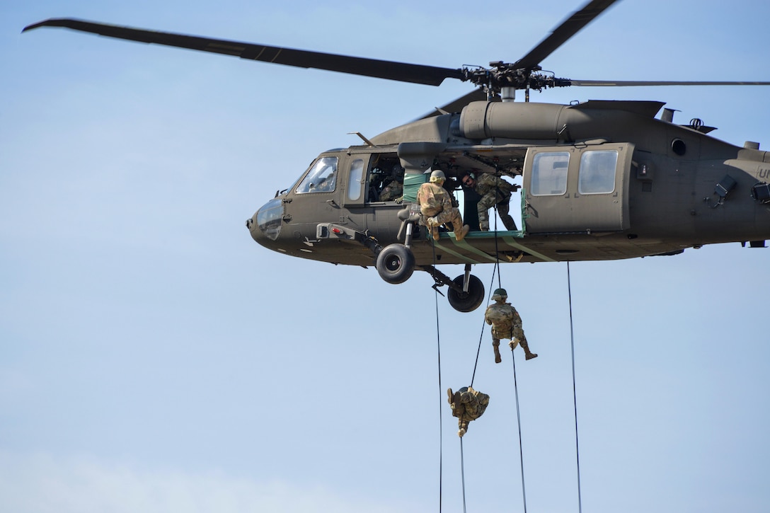 Soldiers rappel from a UH-60M Black Hawk helicopter.
