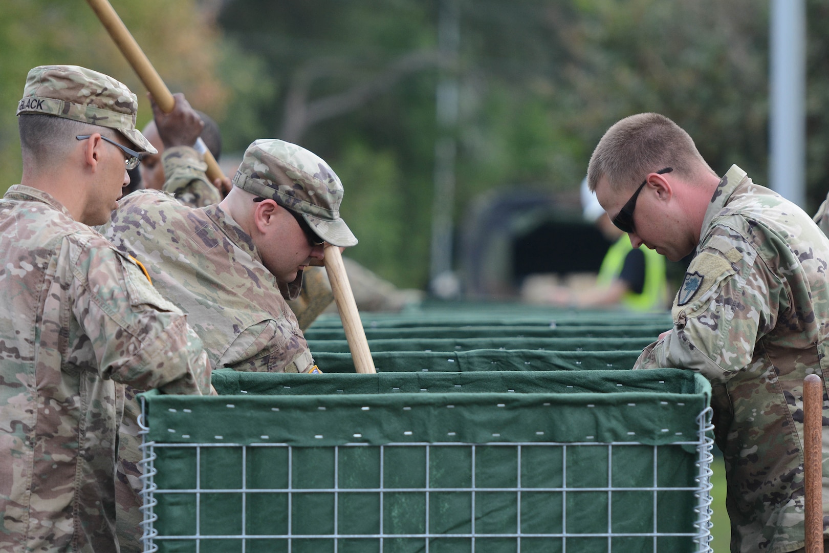 Sgt. Cody Puckett, 1226th Engineering Company training NCO and heavy equipment leader, fills a HESCO water barrier with dirt outside the Tidelands Health Georgetown Memorial Hospital in Georgetown, South Carolina, on Sept. 25, 2018. Approximately 2,000 South Carolina National Guard Soldiers and Airmen are on duty to support local authorities in response and recovery operations to the ongoing flooding that followed Hurricane Florence's landfall. National Guard Soldiers and Airmen from Alaska, Arkansas, Georgia, Maryland, New York, Tennessee, Virginia and Wisconsin are also supporting the South Carolina National Guard recovery efforts.