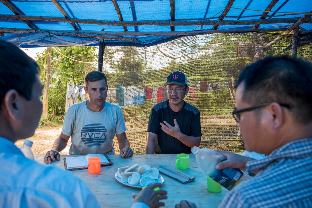 Translator for team seeking missing service members talks with local people in Vietnam.