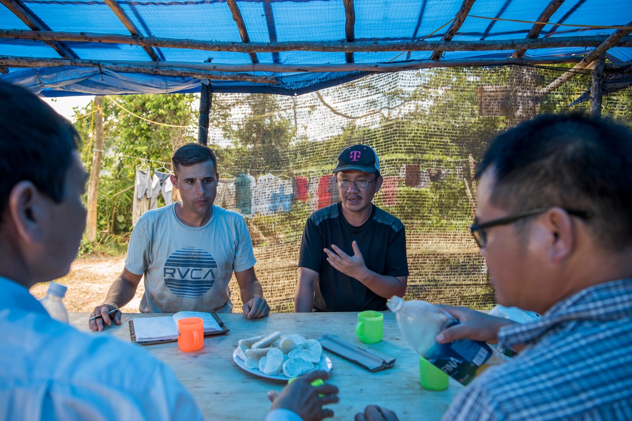 Translator for team seeking missing service members talks with local people in Vietnam.