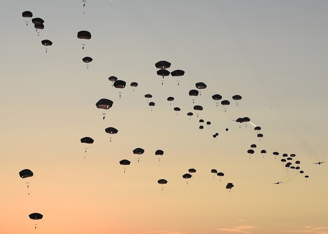 U.S. Army Soldiers from the 173rd Airborne Brigade jump out of U.S. Air Force aircraft over a drop zone in Germany, Sept. 19, 2018. Along with the Army, troops from France, Italy, Czech Republic, and the United Kingdom, jumped during Saber Junction 18. The training with partnered and allied nations helps ensure the effective security of Europe. (U.S. Air Force photo by Staff Sgt. Lauren O'Connor)