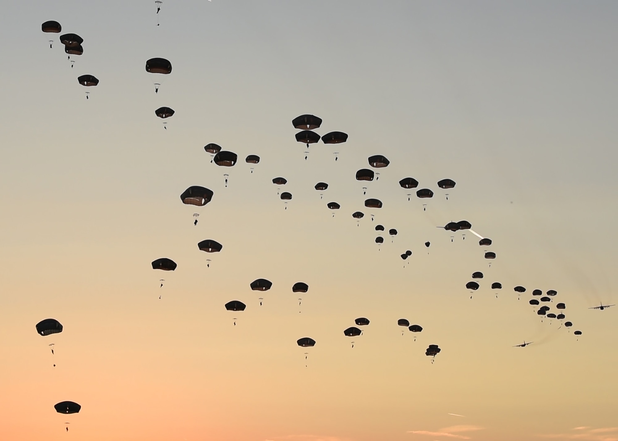 U.S. Army Soldiers from the 173rd Airborne Brigade jump out of U.S. Air Force aircraft over a drop zone in Germany, Sept. 19, 2018. Along with the Army, troops from France, Italy, Czech Republic, and the United Kingdom, jumped during Saber Junction 18. The training with partnered and allied nations helps ensure the effective security of Europe. (U.S. Air Force photo by Staff Sgt. Lauren O'Connor)