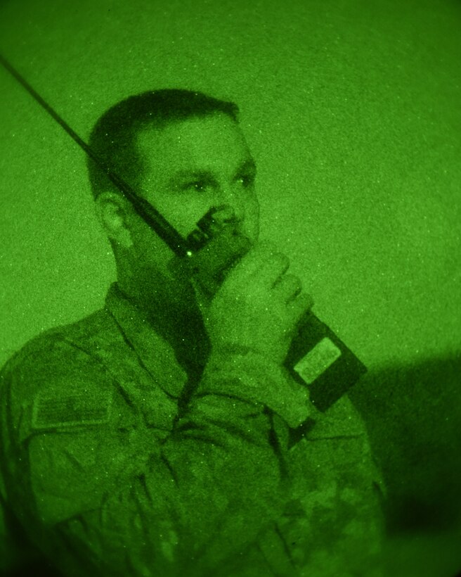 Maj. Jack Talkington, 4th Air Support Operations Group air mobility liaison officer, talks through a radio during Saber Junction 18 in Germany, Sept. 20, 2018. As a liaison between the air and ground components, Talkington helped with the planning and development of operations of SJ18. Saber Junction 18 works to ensure U.S. Forces in Europe maintain readiness and lethality. (U.S. Air Force photo by Staff Sgt. Lauren O'Connor)