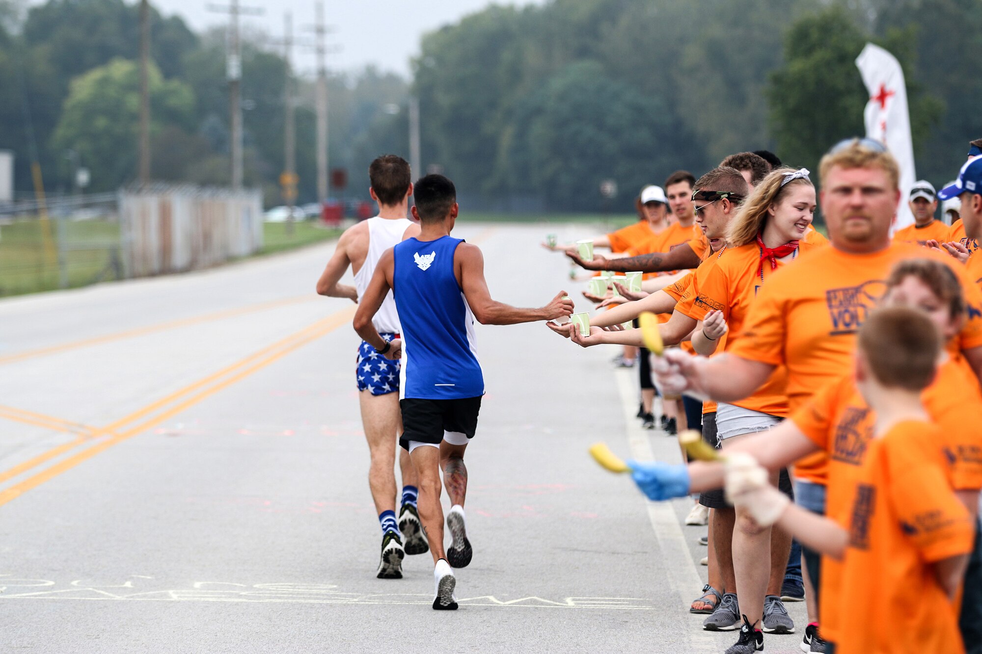 Airmen and families of the 445th Airlift Wing serve as volunteers for the Air Force Marathon Sept. 15,2018. The volunteers cheered and provided snacks and beverages to runners as they ran past the hydration station set up at the 445th AW.