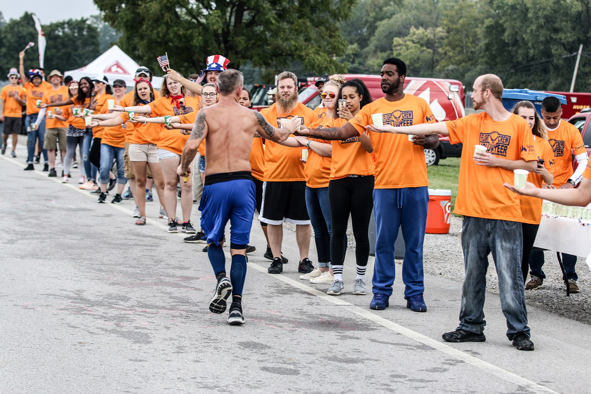 Airmen and families of the 445th Airlift Wing serve as volunteers for the Air Force Marathon Sept. 15,2018. The volunteers cheered and provided snacks and beverages to runners as they ran past the hydration station set up at the 445th AW.