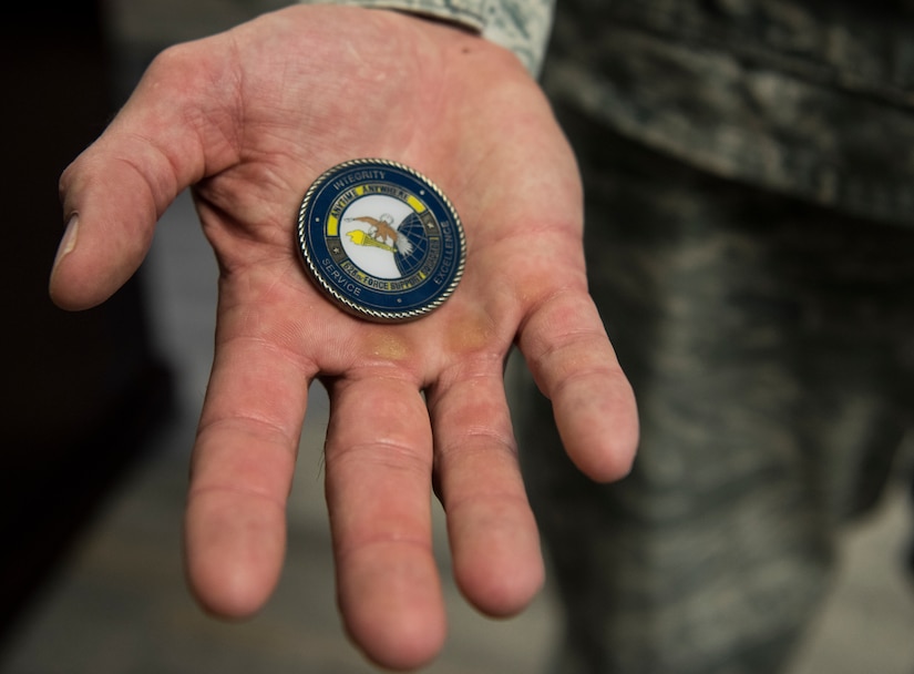 Lt. Col. William Parker, 628th Force Support Squadron commander, holds his unit coin Aug. 30, 2018. Honoring someone with a commander’s coin is a way for senior leadership to show their appreciation for a phenomenal job on the spot. It is more than just a thank you or a pat on the back, it is something tangible to remember the moment by.