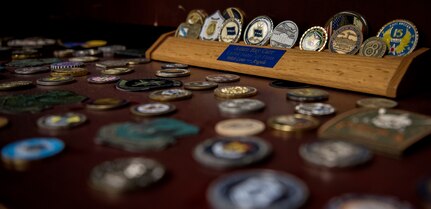 Senior Master Sgt. Adam Carr, 628th Comptroller Squadron wing staff agencies superintendent, displays his coin collection in his office at Joint Base Charleston, S.C. Many military members can remember a time when they got coined, whether it was the first coin they ever received or a coin they were awarded from a special moment.