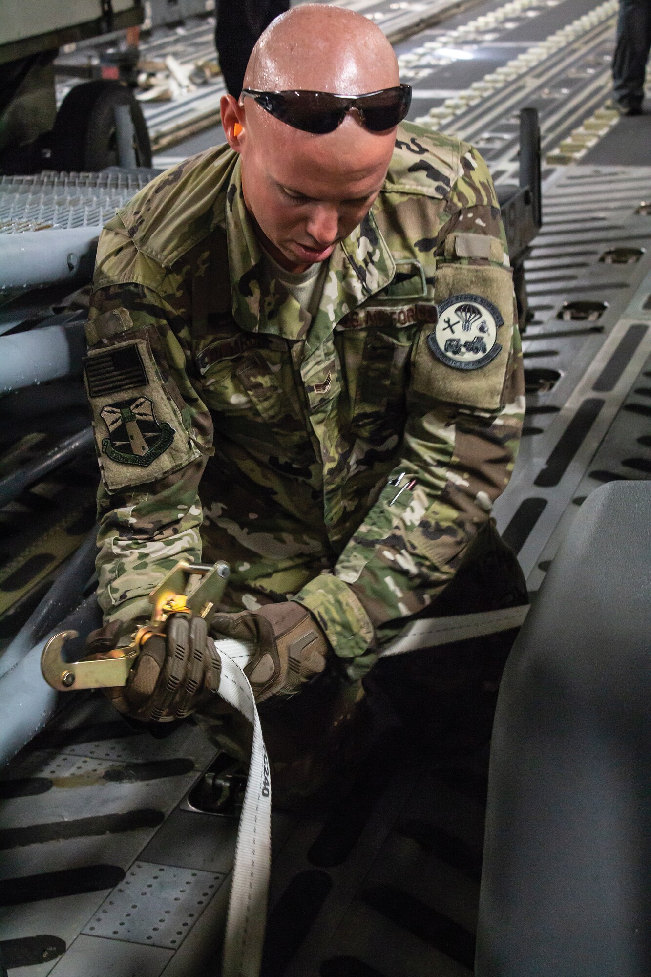 Senior Airman Nathan Edwards, 920th Logistics Readiness Squadron aerial delivery air transportation specialist, secures equipment on a 445th Airlift Wing C-17 Globemaster III Sept. 13, 2018. The equipment was transported from Patrick Air Force Base, Florida, to Moody Air Force Base, Georgia, Sept. 13, 2018, to help with hurricane relief efforts.