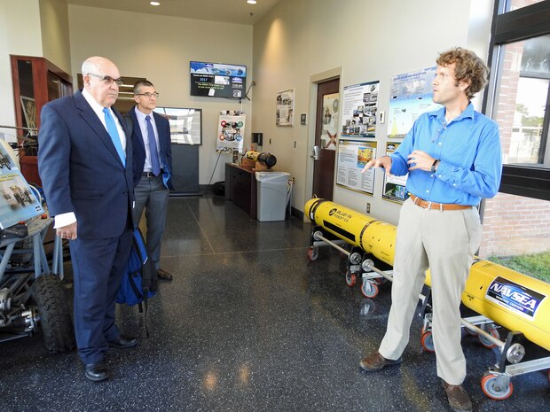 PANAMA CITY, Florida - Naval Surface Warfare Center Panama City Division (NSWC PCD) Autonomous Systems Engineer Dr. Matthew Bays discusses unmanned underwater vehicles, robotics, and autonomy with Virginia Polytechnic Institute and State University's Senior Advisor Capt. Jon Greene, USN Ret. (left) and Center for Marine Autonomy and Robotics Director Dr. Dan Stilwell (center), during a collaboration and recruiting visit at NSWC PCD Sept. 26, 2018. U.S. Navy photo by Susan H. Lawson