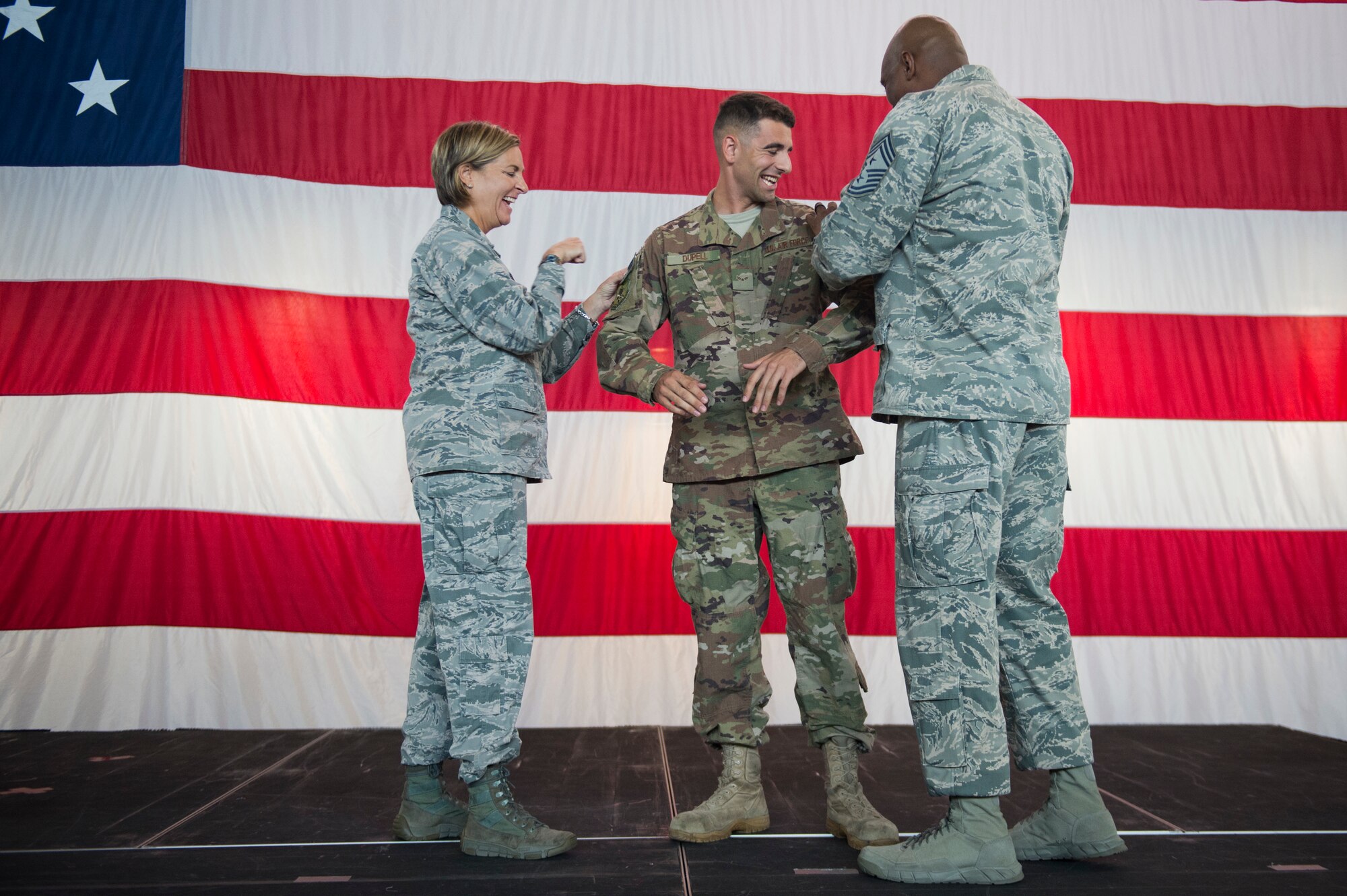 Col. Jennifer Short, 23d Wing commander, and Chief Master Sgt. James Allen, 23d Wing Command Chief, tack on Airman 1st Class Aaron Dupell, 723d Aircraft Maintenance Squadron with senior airman below the zone (BTZ) stripes during a commander’s call, Sept. 24, 2018, at Moody Air Force Base, Ga. Senior Airman BTZ promotes an E-3 to E-4 six months earlier than normal and is only given to the most outstanding Airmen. (U.S. Air Force Photo by Andrea Jenkins)