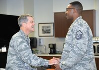 Maj. Gen. John J. DeGoes, 59th Medical Wing commander, presents a command coin to Master Sgt. Andre C. Denson, medical equipment management section chief, at Wilford Hall Ambulatory Medical Center on Joint Base San Antonio-Lackland, Texas, Sept. 17. DeGoes coined Denson for his recent life-saving actions in which he performed the Heimlich maneuver on a patron who was choking in the WHASC’s food court area.