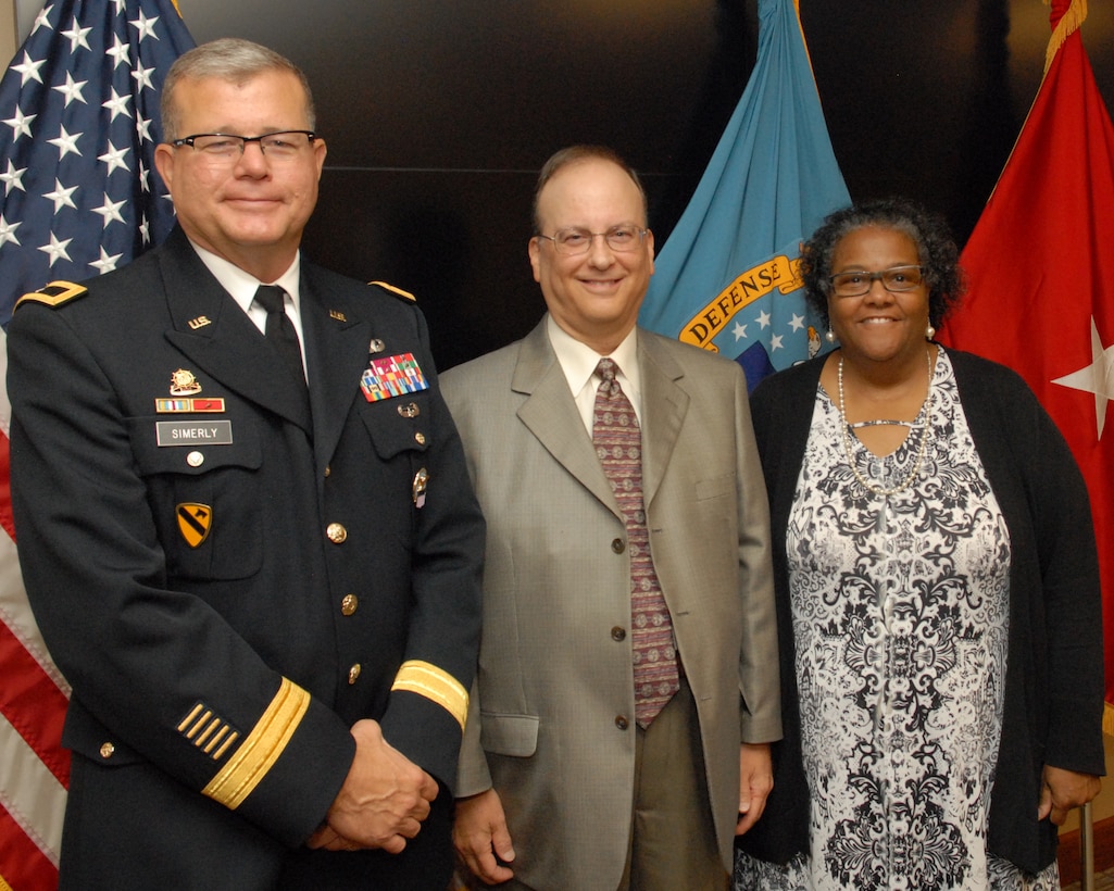 Anita Parker (right) and Philip DiBabbo (center) pose with DLA Troop Support Commander Army Brig. Gen. Mark Simerly (left) after being recognized for their service during a retirement ceremony Sept. 26 in Philadelphia.